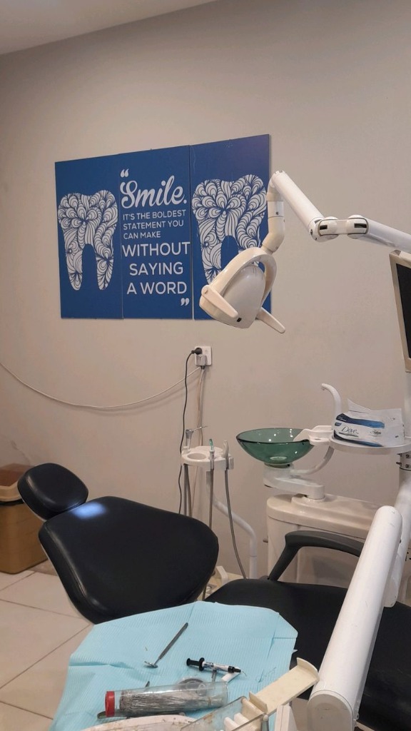 Modern dental operatory room with blue dental chair and advanced equipment