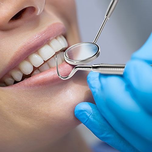 Detailed clinical dental tools being used for an examination on a patient