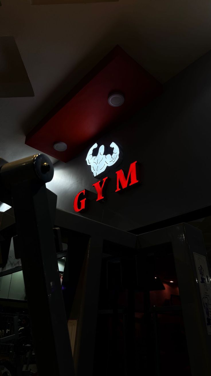 Apex Fitness Club interior neon logo and weight rack area