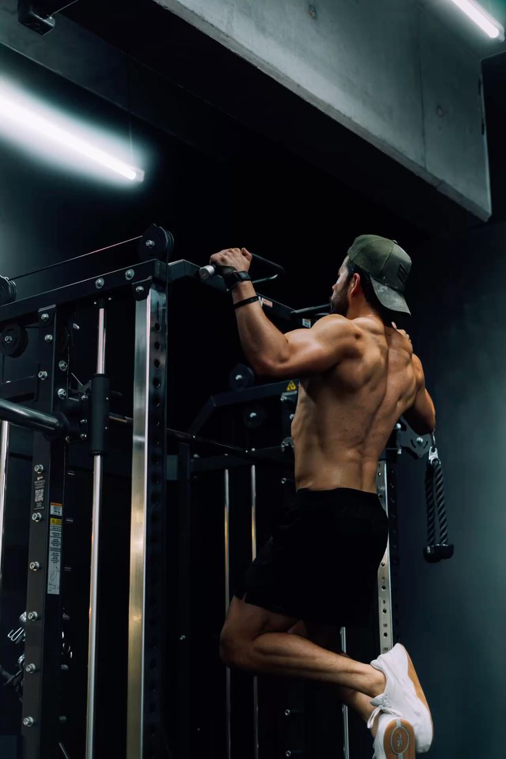 Trainer spotting a client performing single-leg kettlebell squats