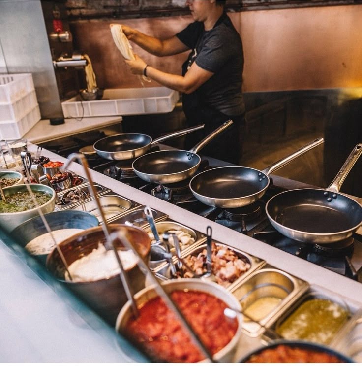 Chef preparing food in authentic wood-fired tandoor style kitchen
